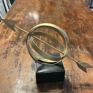 Gold armillary sphere with arrow decor